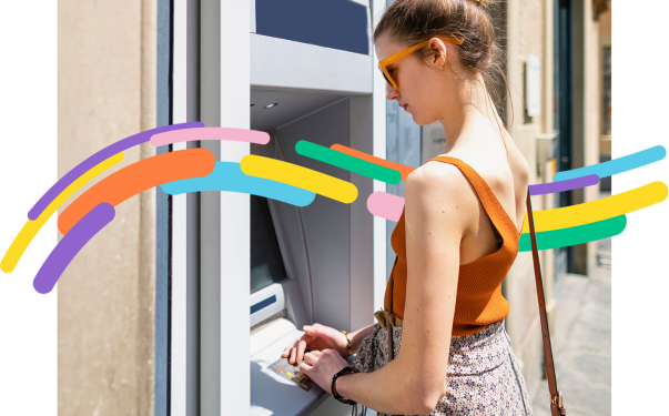 a girl using ATM 
